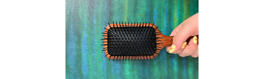 person holding different types of hair brushes