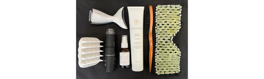 lay out of an eye mask, scalp brush, detox mask, harmonic healing oil, magnifier, led light, and silicone scrubber